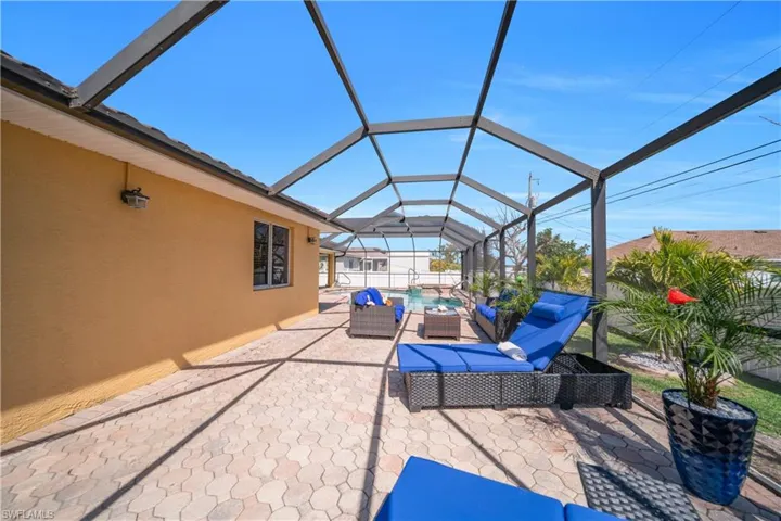 View of patio / terrace with outdoor seating, a sunroom, glass enclosure, and an outdoor pool