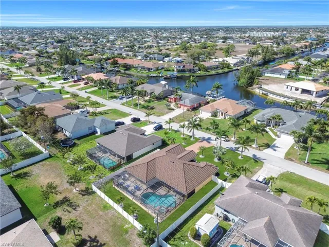 Aerial perspective of suburban area with a nearby body of water