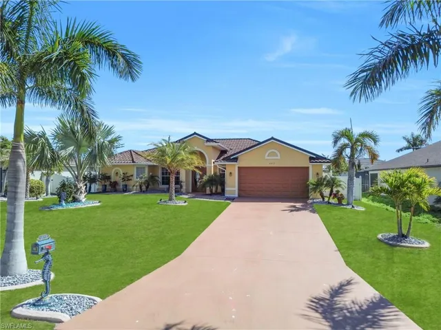 Mediterranean / spanish home featuring stucco siding, a front yard, an attached garage, concrete driveway, and a tiled roof