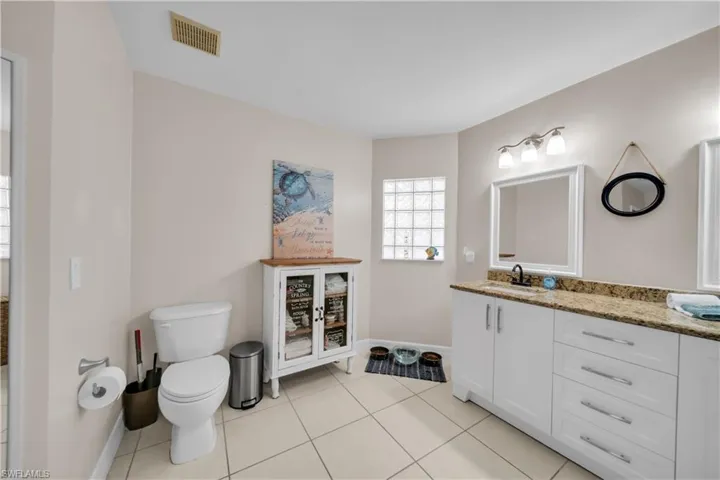Bathroom with vanity and light tile patterned floors