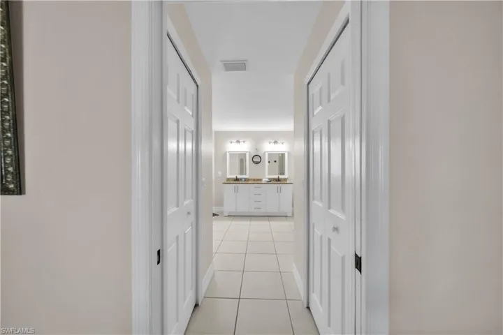 Corridor with light tile patterned floors