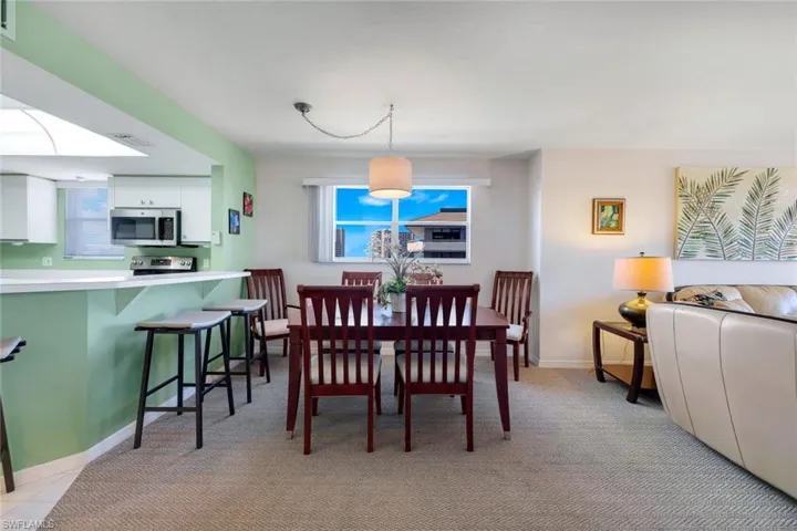 Dining room featuring light carpet
