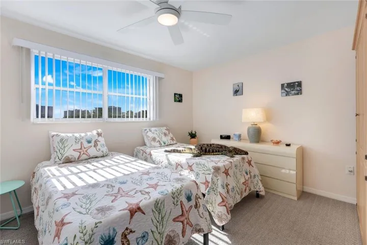 Bedroom featuring light carpet and ceiling fan