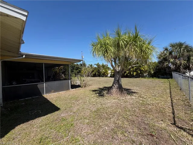 View of yard featuring a screened in lanai