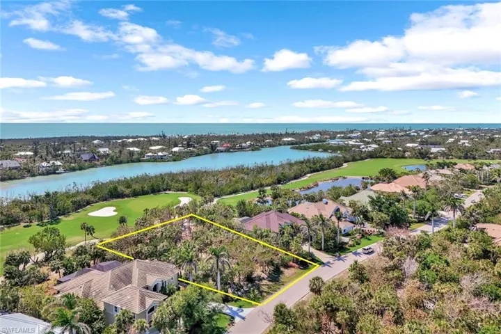 Birds eye view of property featuring golf course view and a water view