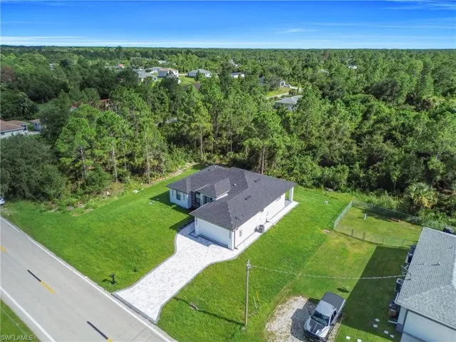 View of subject property with a forest