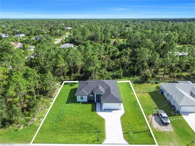 View from above of property featuring a heavily wooded area and property boundaries highlighted