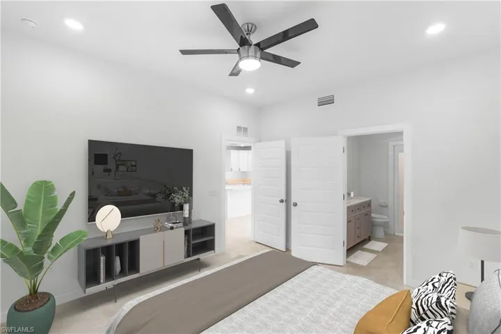 Bedroom with recessed lighting, ceiling fan, and connected bathroom