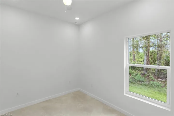Empty room with baseboards and recessed lighting