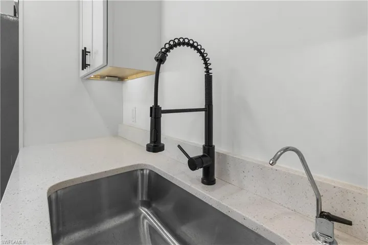Kitchen view of light stone countertops and white cabinets