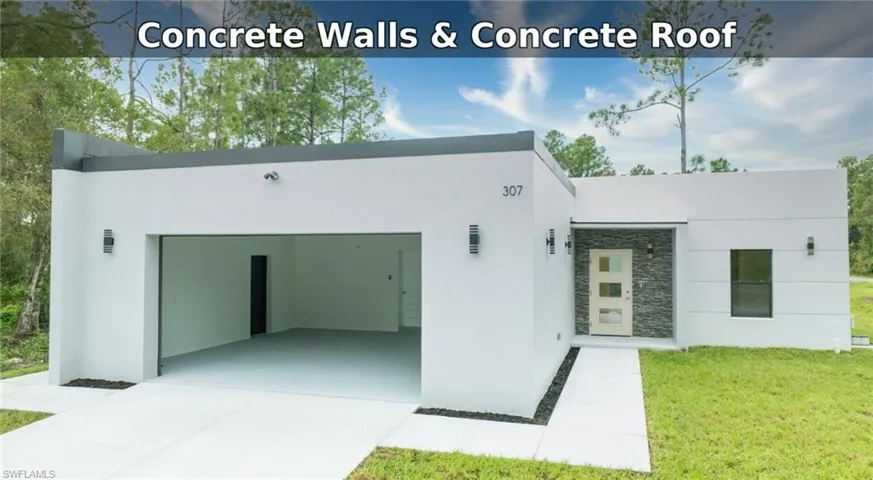 Insulated Concrete Form house, Solid poured walls and Concrete front of property featuring stone siding, stucco siding, driveway, a garage, and a front lawn