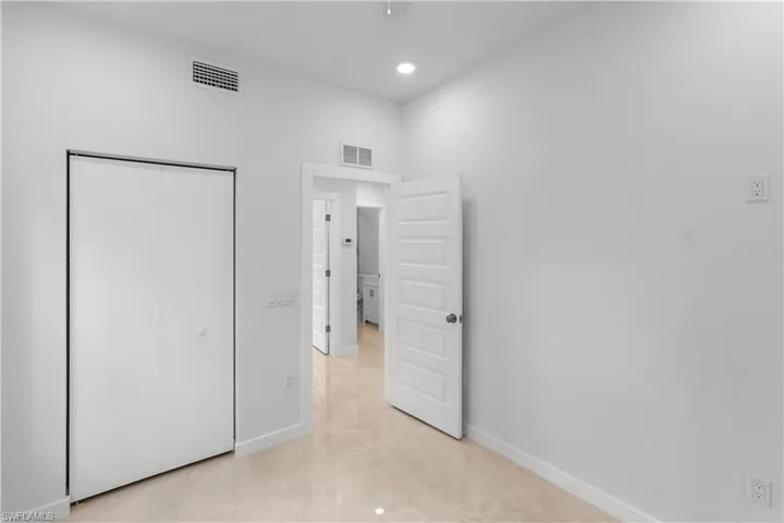 Unfurnished bedroom with a closet, light tile patterned floors, recessed lighting, and a ceiling fan