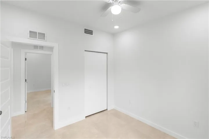 Unfurnished bedroom with a closet, ceiling fan, light tile patterned floors, and recessed lighting