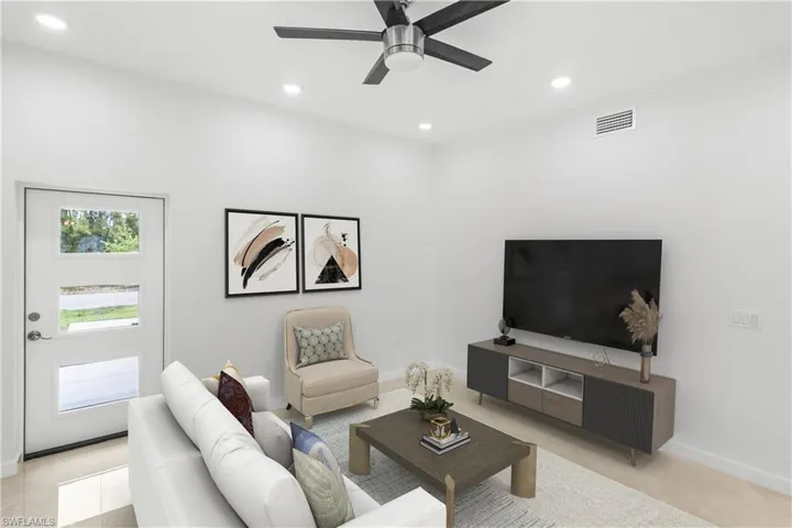 Living room featuring recessed lighting and a ceiling fan