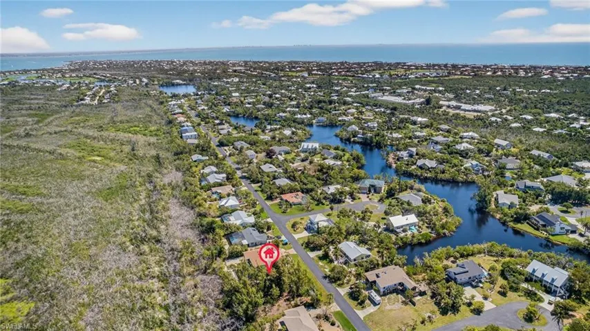 Aerial perspective of suburban area featuring a large body of water