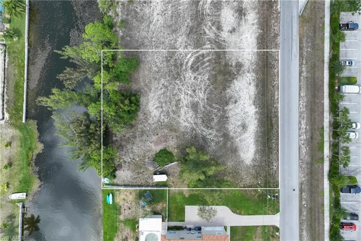 Aerial view of property's location with a nearby body of water and property parcel outlined