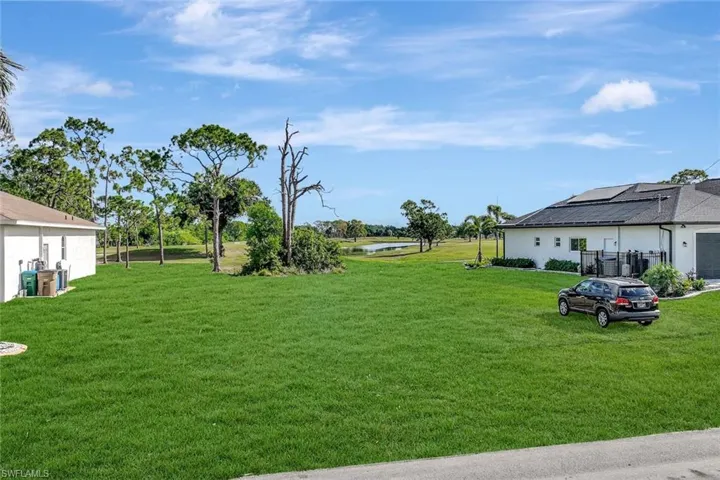 View of green lawn with a water view