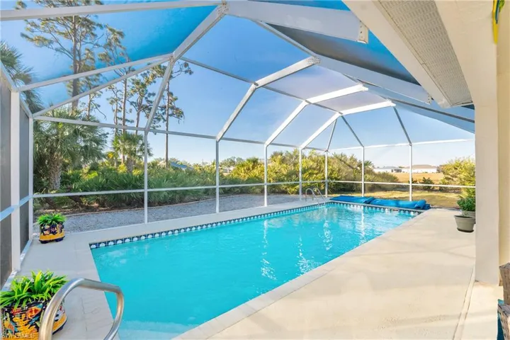 View of swimming pool featuring a lanai and a patio