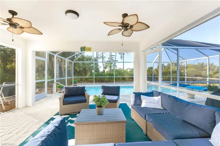 View of patio / terrace with glass enclosure, ceiling fan, and an outdoor hangout area
