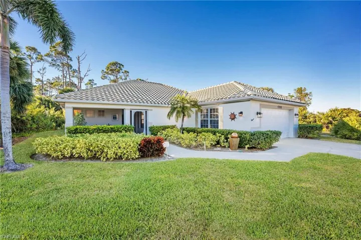 Mediterranean / spanish-style house with a front lawn and a garage