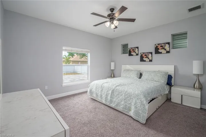 Bedroom featuring a vaulted ceiling and carpeting
