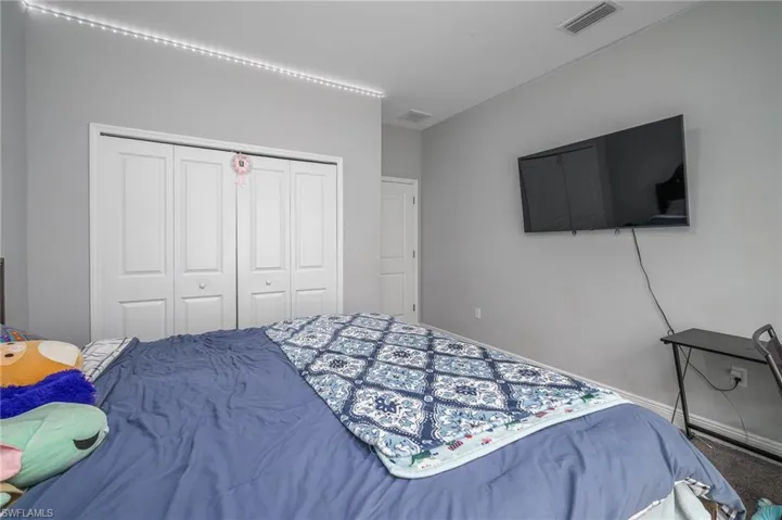 Interior room featuring neutral wall paint, bi-fold closet doors, and recessed ceiling lighting