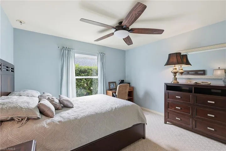Bedroom featuring light colored carpet and ceiling fan