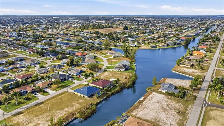 Aerial overview of property's location featuring a large body of water and nearby suburban area