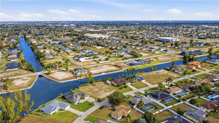 Aerial view of property's location with nearby suburban area and a large body of water