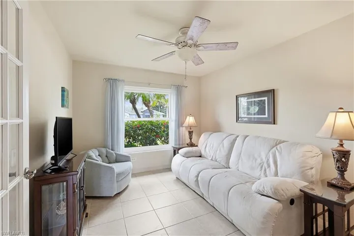 Tiled Den/Office with a ceiling fan and baseboards