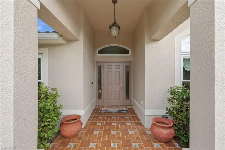 View of exterior entry featuring stucco siding