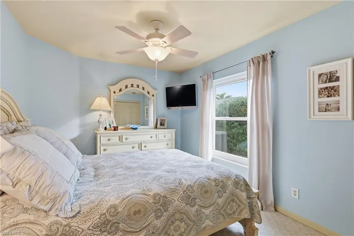 Bedroom featuring light colored carpet and ceiling fan