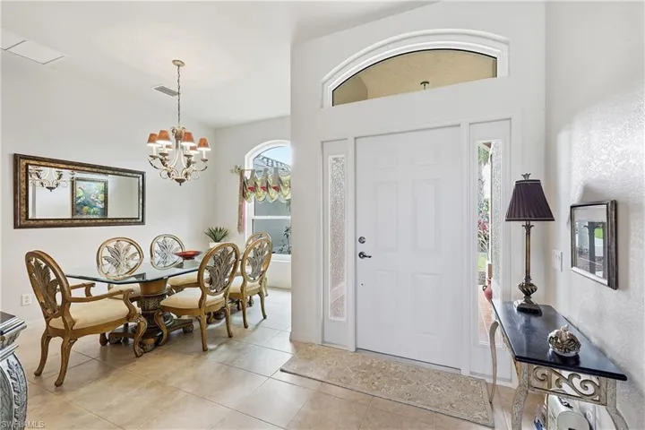 Entrance foyer featuring light tile patterned floors and a chandelier