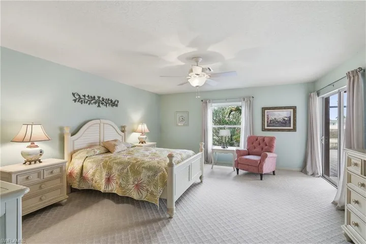 Bedroom featuring access to outside, carpet, a ceiling fan, and a textured ceiling