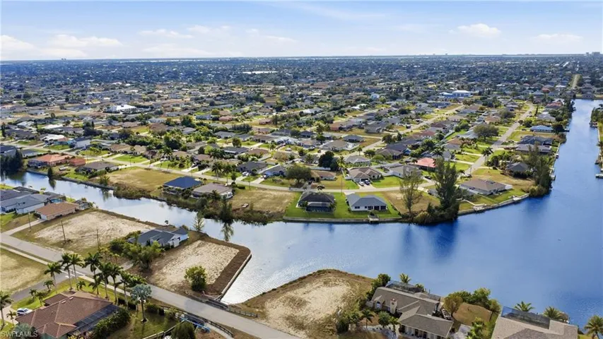 Aerial perspective of suburban area with a large body of water