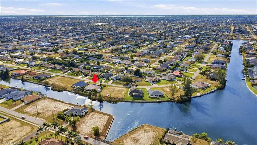 Aerial view of property's location with nearby suburban area and a nearby body of water