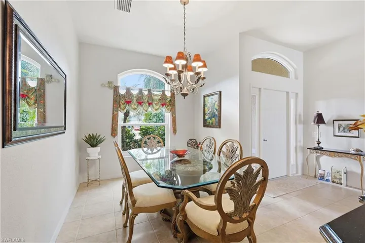 Dining space featuring light tile patterned floors and a chandelier