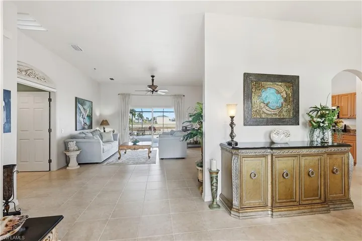 Living room featuring a ceiling fan and light tile patterned floors