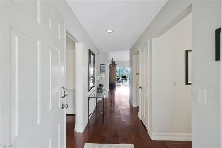 Hallway featuring dark wood-style floors and recessed lighting