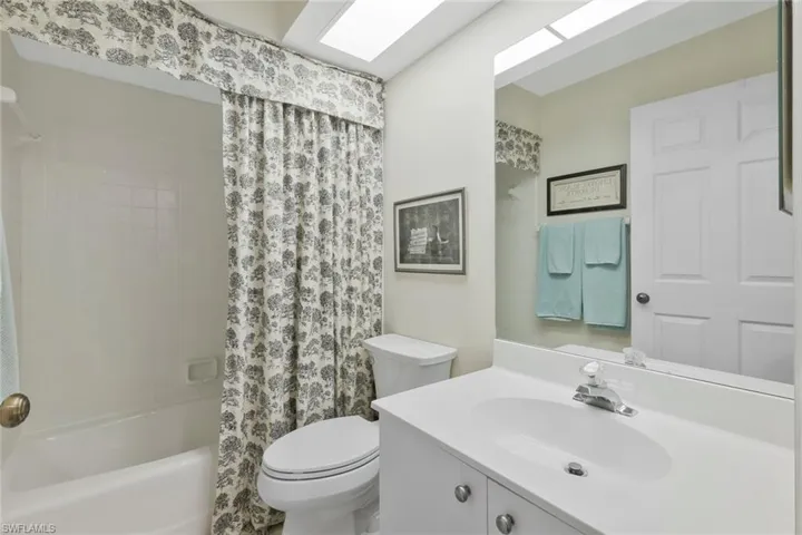 Full bathroom featuring vanity and shower / bath combo with shower curtain