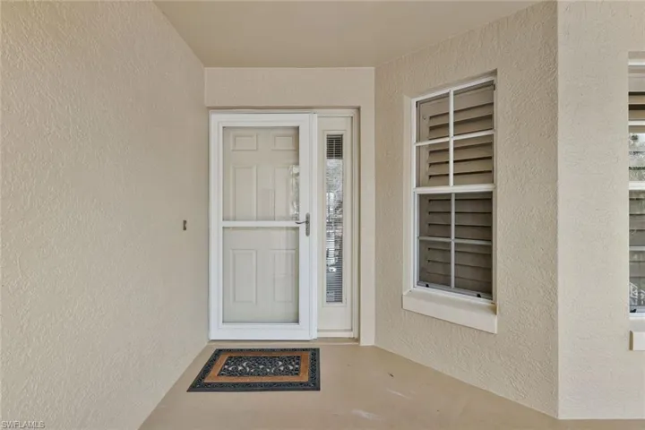Doorway to property with stucco siding