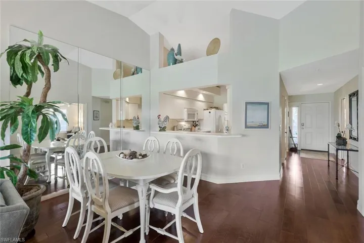 Dining area featuring dark wood finished floors and lofted ceiling
