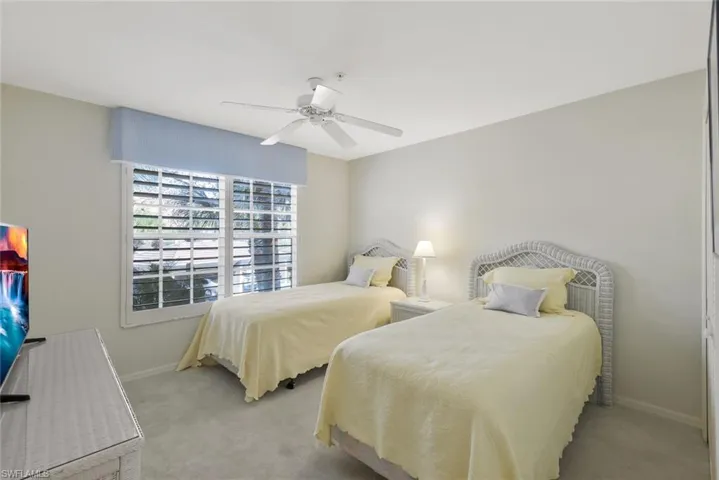 Bedroom with carpet floors and a ceiling fan
