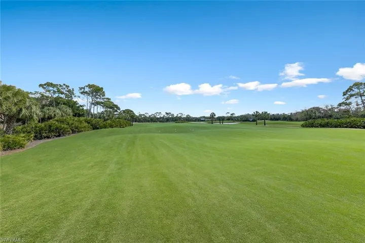 View of property's community featuring golf course view and view of scattered trees
