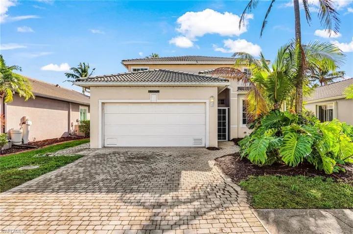 Mediterranean / spanish-style house featuring stucco siding, decorative driveway, a tile roof, and an attached garage
