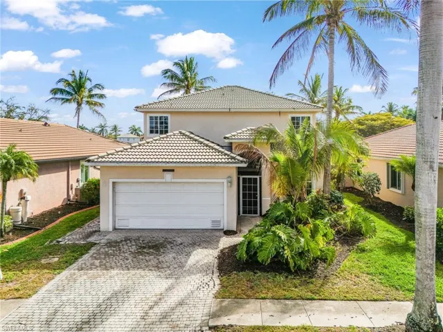 Mediterranean / spanish-style house featuring stucco siding, a tiled roof, decorative driveway, and an attached garage
