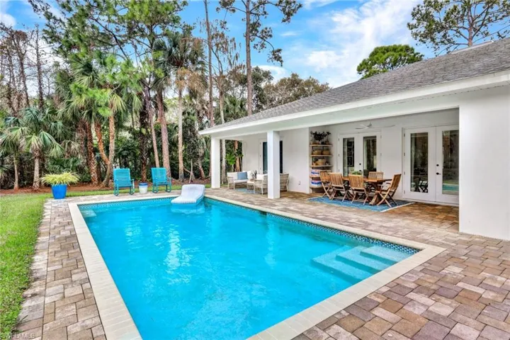 Outdoor pool featuring french doors, a patio, an outdoor hangout area, and outdoor dining space