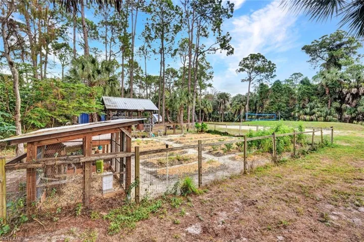 View of yard featuring an outbuilding and a garden