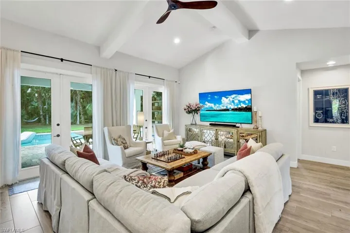 Living room featuring french doors, light wood-style flooring, recessed lighting, and a ceiling fan