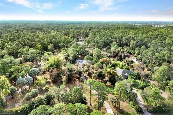 Aerial overview of property's location with a heavily wooded area